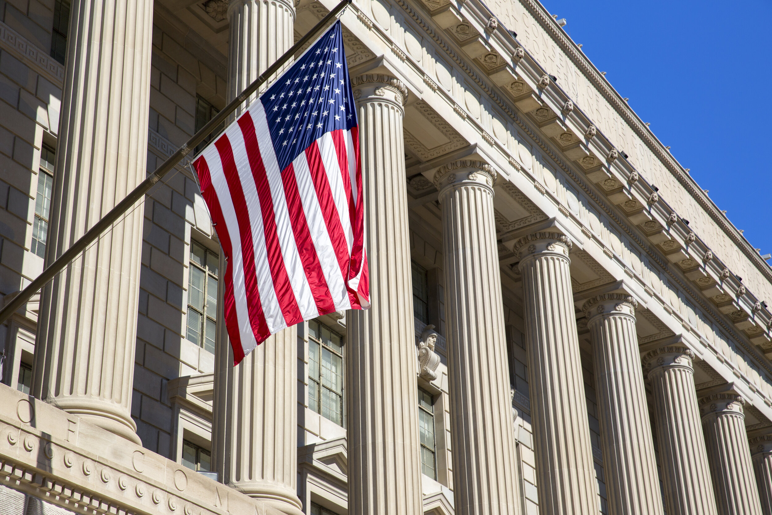 American Flag flying in front of a Government building